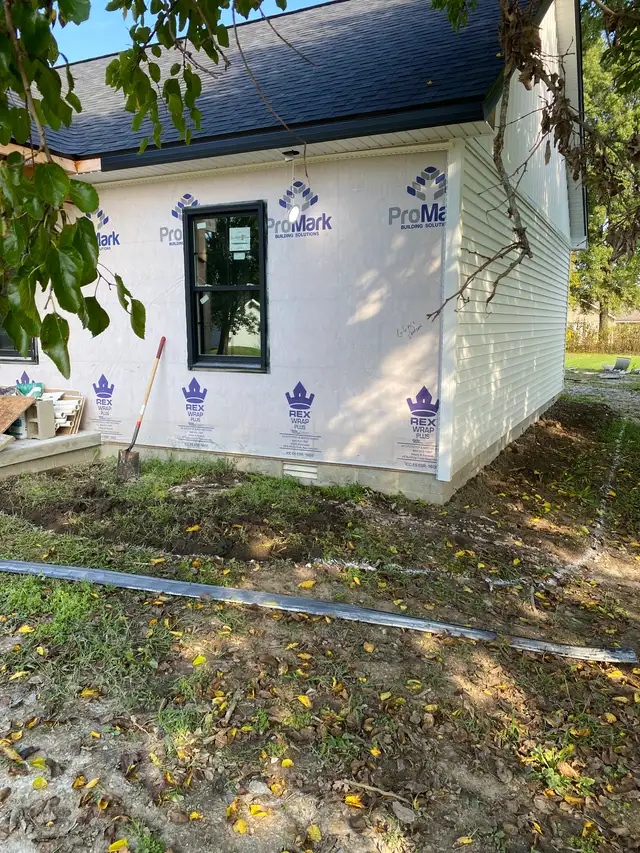 Soil preparation along the edge of a building.
