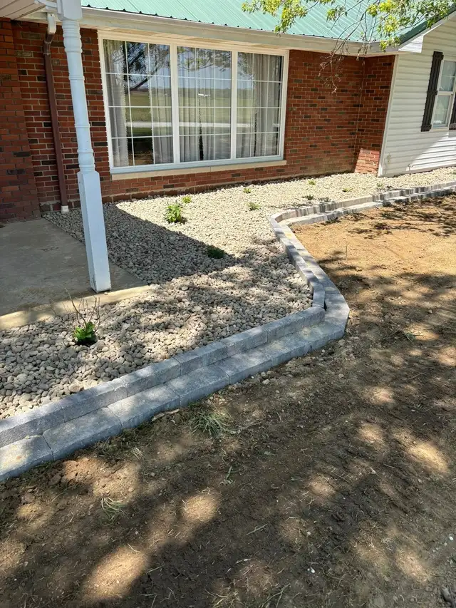 Decorative stone and planting within a gray garden border.