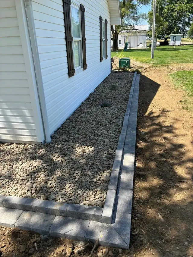Stone ground cover and small shrubs along a garden border.